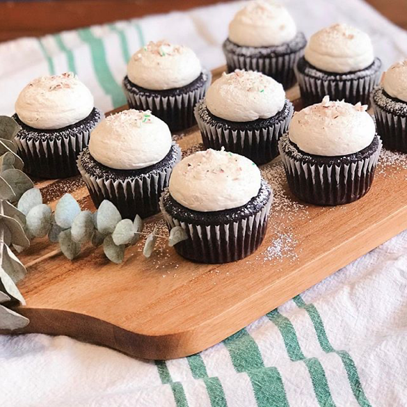 Vegan Chocolate Peppermint Cupcakes with Buttercream Icing topped with Powdered Sugar and Crushed Candy Cane